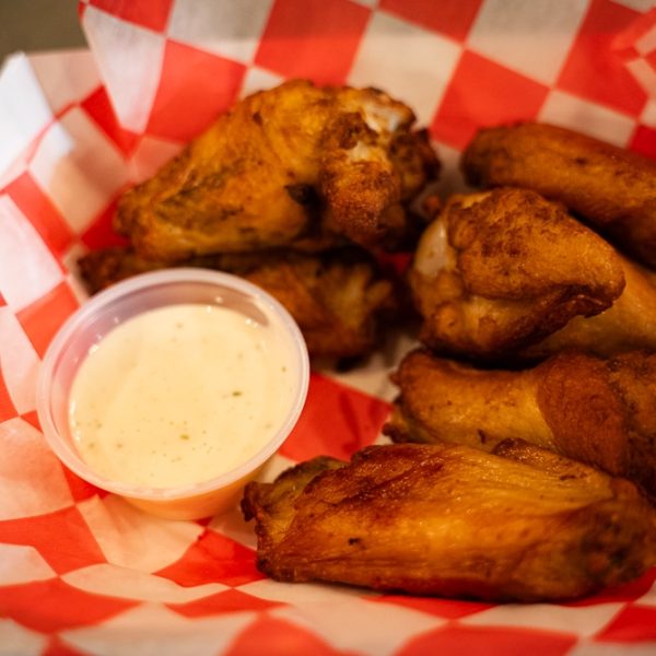 chicken wings and sauce at Common John Brewing Company
